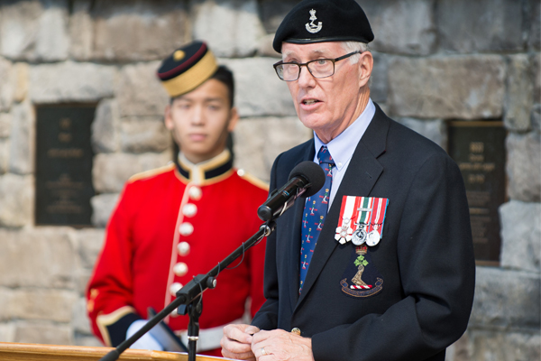 Ex cadet Jim Leech at the Wall of Honour with a cadet looking on.