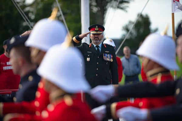 A general officer ex-cadet of RMC salutes officer cadets in a march past